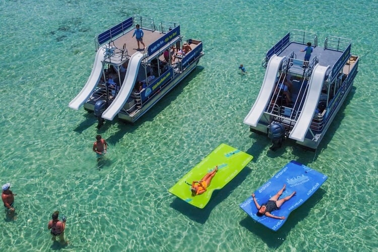 aerial view of two double decker pontoons and lily pads near crab island destin fl