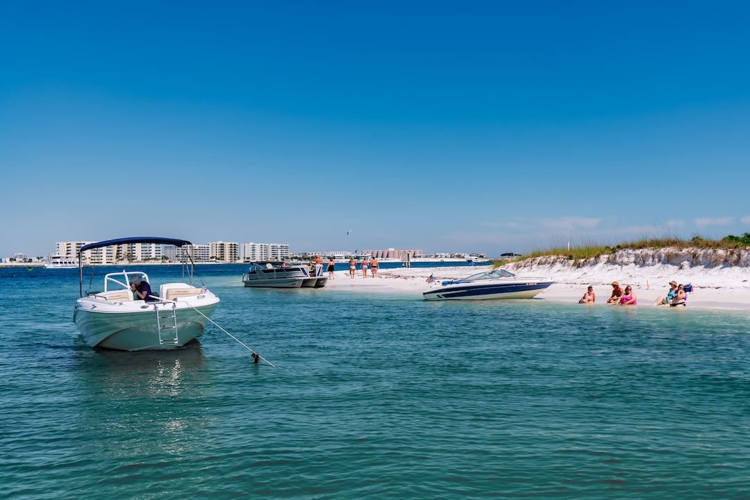 boats floating near a beach in the Choctawhatchee Bay