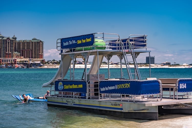 double decker pontoon parked at west jetty beach with family playing in the water destin fl