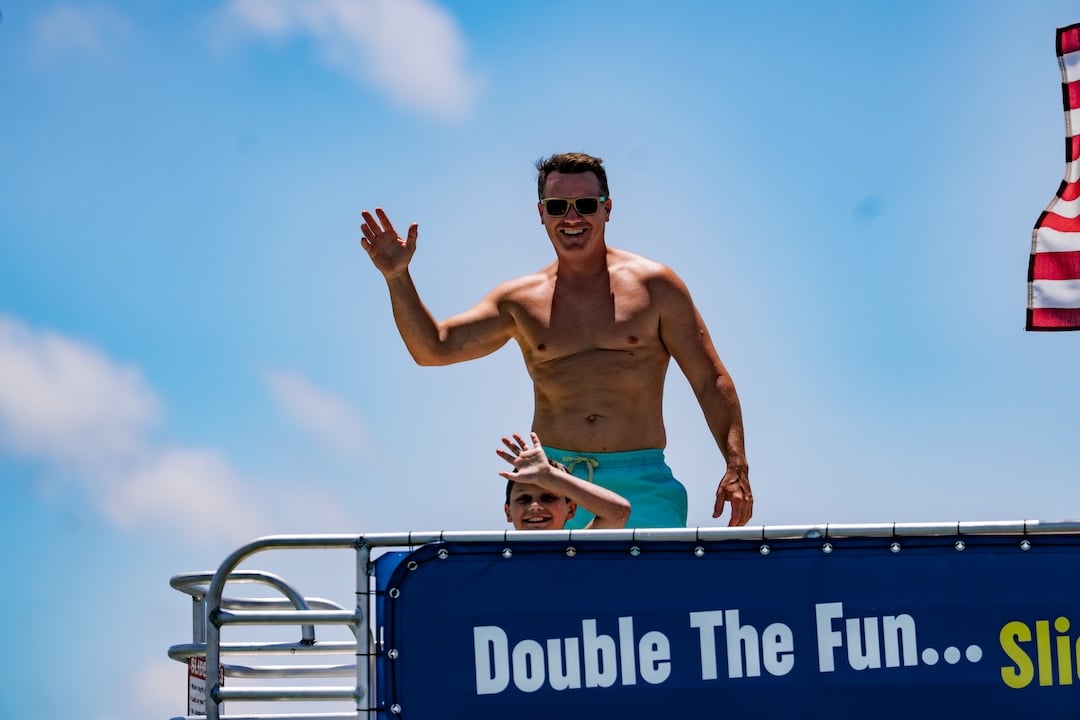 man on top of a double decker pontoon at crab island