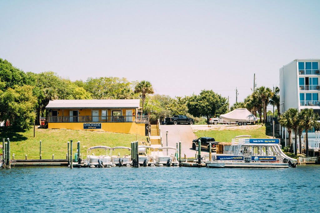 double decker pontoon boat parked outside of dockside in destin, florida