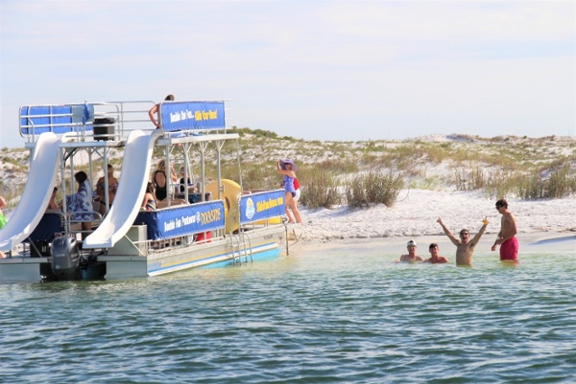 double decker pontoon boat parked off of west jetty beach in destin florida