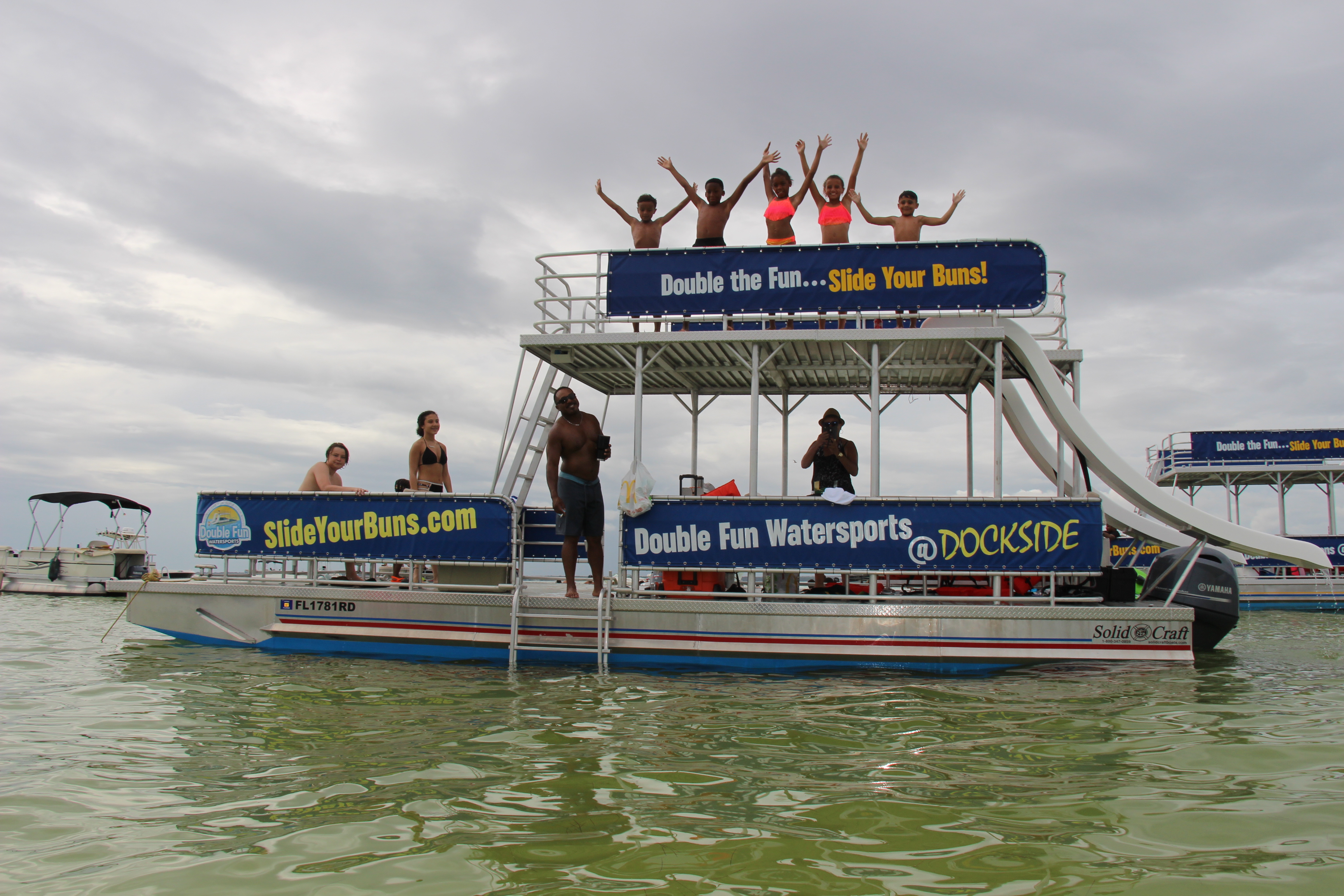 double decker pontoon boat parked in the ocean