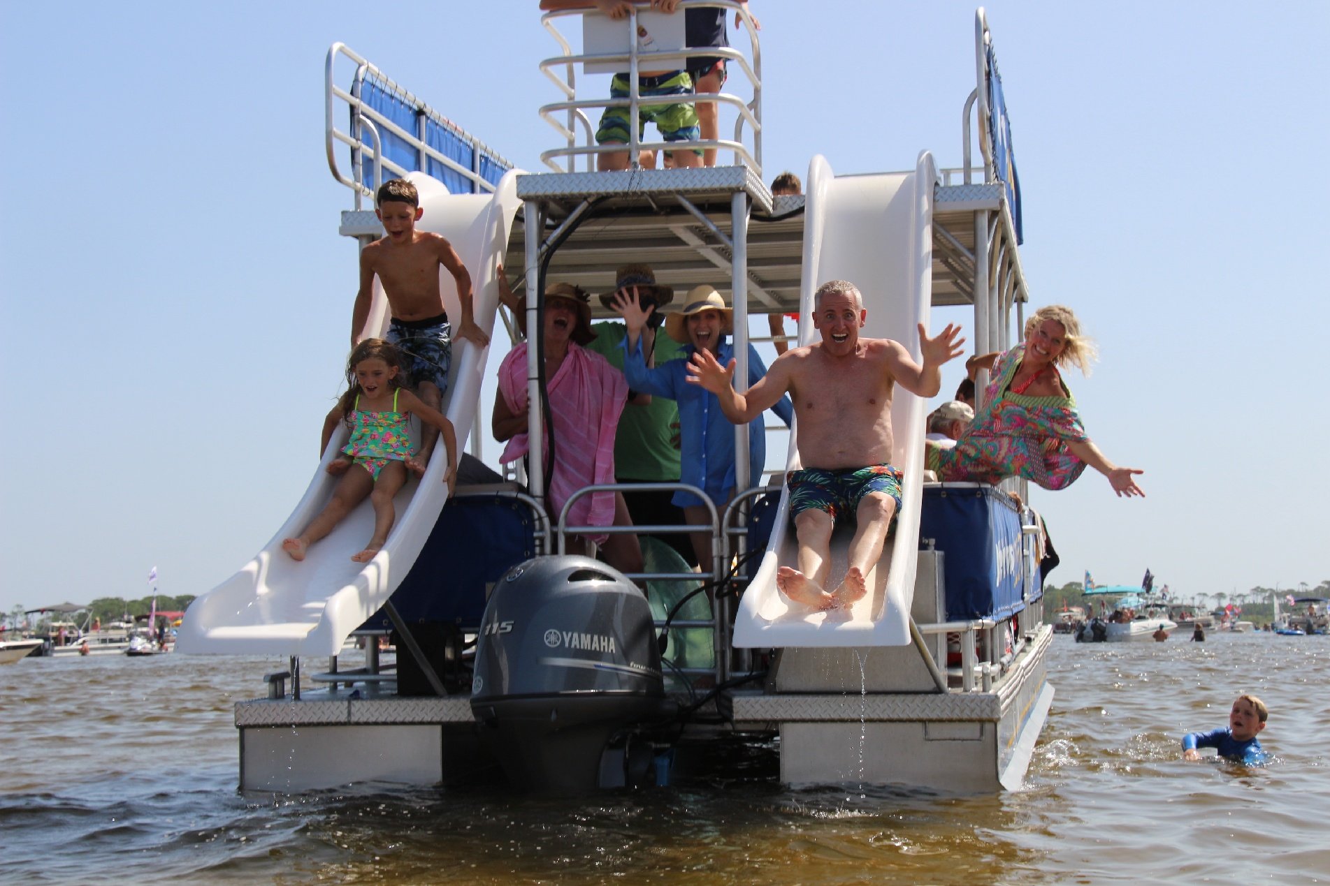 family sliding down two double decker pontoon boat slides in destin, florida 