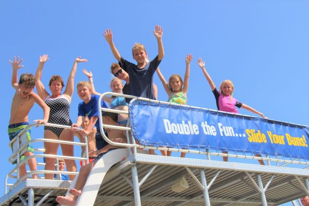 kids standing on top of a double decker pontoon boat in destin, florida