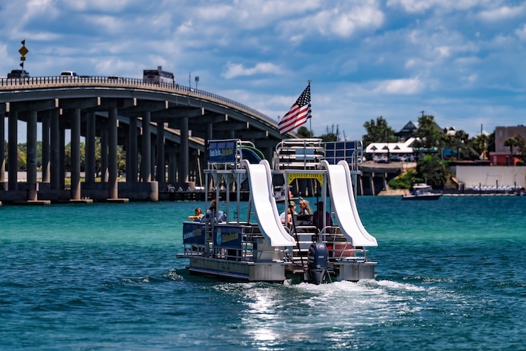double decker boat cruising in destin harbor near destin bridge
