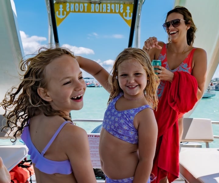two girls dancing on a double decker pontoon rental in destin florida